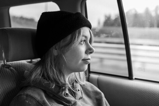  Pretty Girl With Pink Hair In A Black Knitted Hat In The Back Seat Of A Car