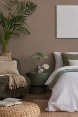 Creative composition of bedroom interior with mock up poster frame, braided pouf, plants, gray...