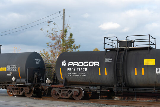black Procor tank cars crossing grade level at Old Weston Road and Junction in Toronto, Ontario