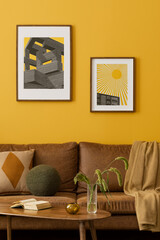 Interior design of yellow living room interior with mock up poster frame, brown sofa, wooden coffee table, slippers, green rug, basket, orange lamp and personal accessories. Home decor. Template.