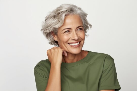 Attractive Mature woman smiling and relaxing and looking aside on copyspace . Nice portrait of senior woman