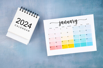 January 2024 calendar page with on wooden background.