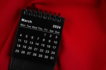 March 2024 Black spiral desktop calendar.