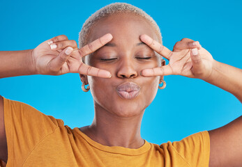Kiss, black woman and peace hands on face in studio for self love, thank you or good vibes on blue background. V, sign and African female with cool mood, pose or freedom emoji for support or swag