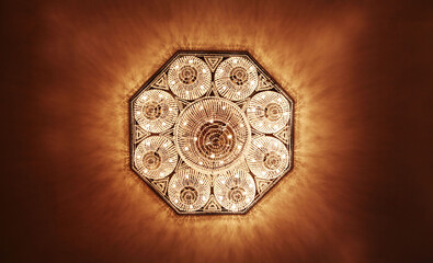 The radiant glow of the overhead ceiling light casts a warm and inviting ambiance throughout the room. 