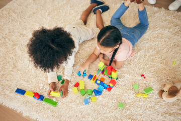 Relax, play and above of children on floor with building blocks for learning, education and child development. Family, home and top view of girls in living room with toys for fun, creativity or games