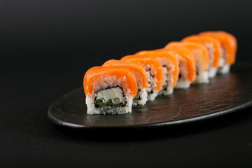 sushi rolls beautifully laid out on the table by Italians, serving sushi to a client, beautiful photos of sushi for advertising