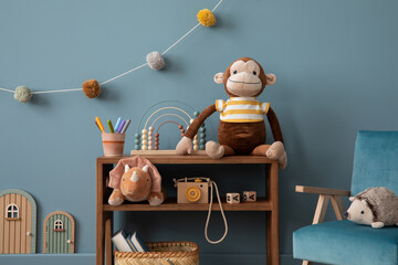 Aesthetic composition of warm child room interior with wooden sideboard, blue wall, stylish...