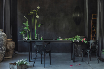 Interior design of japandi dining room interior with black table, round stool, stylish chair, glass...
