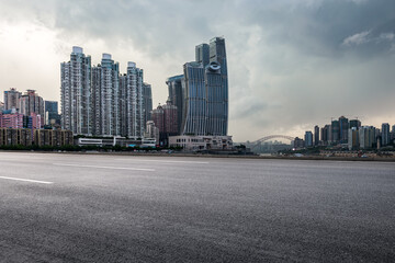 Fototapeta na wymiar Asphalt road and city buildings skyline in Chongqing at sunset