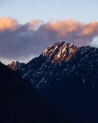 Golden sunset light hitting snow capped mountain peaks in Golden Ears Provincial Park. Maple Ridge,...