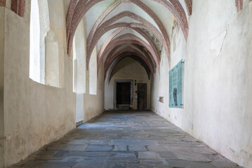 Obraz premium Novacella Augustinian Abbey. The Gothic cloister with from valuable frescoes, Brixen (Bressanone), South Tyrol, northern Italy, Juni 12, 2023