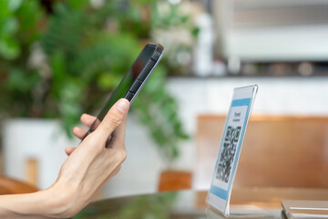 Woman use smartphone to scan QR code to pay in cafe restaurant with a digital payment without cash. Choose menu and order accumulate discount. E wallet, technology, pay online, credit card, bank app.