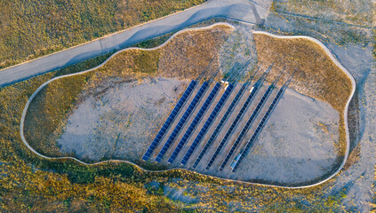 Solar panel station surrounded by a fence. View from a drone