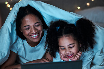 Mom, child and tablet with blanket in bedroom at night to play games, social media and reading ebook. Happy mother, girl and kid relax with digital technology, watching cartoon or movies in dark fort - obrazy, fototapety, plakaty