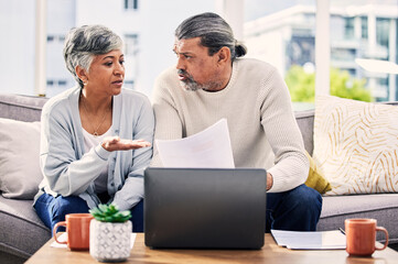 Senior couple, documents and stress on laptop with financial paperwork, taxes or retirement...