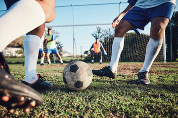 Ball, soccer and men with exercise, grass and health with workout goal, fitness and motion with action. Male players, speed or athlete with a challenge, football and sports with competition or energy © C. Daniels/peopleimages.com