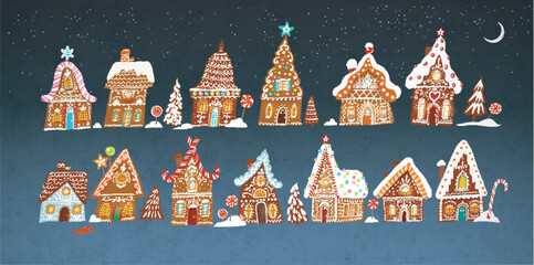 Obraz premium Set of gingerbread houses decorated with christmas sweets on night sky background