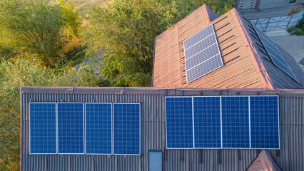 Photovoltaic modules on the roof of a house. View from a drone