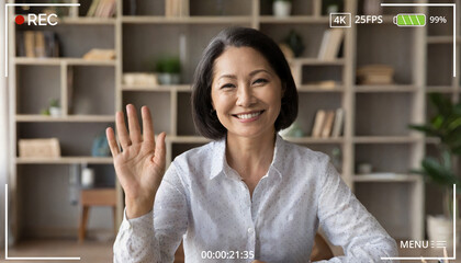 Happy mature middle aged woman online teacher waving hand talking to web cam video conference calling in virtual webcamera chat meeting by distance remote vidoecall. Headshot portrait. Webcam view - obrazy, fototapety, plakaty