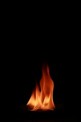 Vertical shot of flames isolated on a black background for textures