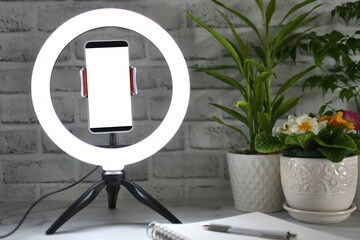 Desk ring light with blank phone screen - Concept mock up for blogger influencer online teaching