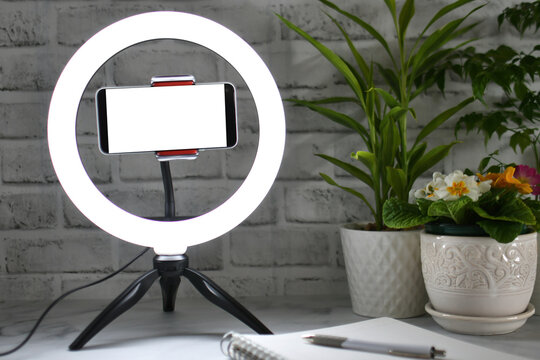 Desk ring light with blank phone screen - Concept mock up for blogger influencer online teaching