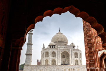 View of the imposing Taj Mahal in Agra, India, with its wonderful architecture on a cloudy day from the side