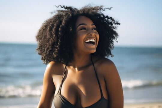 Young chubby black woman having fun at beach. Cheerful friends enjoying at sea.