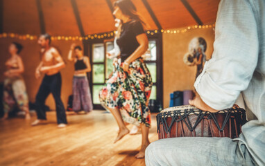 Drummer playing the djembe at the cacao ceremony. Ceremony dance in circle. Ceremony space. - obrazy, fototapety, plakaty