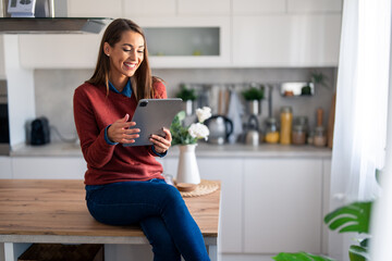 Happy woman freelancer working remotely over digital tablet pc from home.