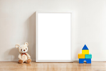 white wood frame canvas mockup template in kids nursery room with teddy bear and wooden block toys A4 transparent placeholder space - obrazy, fototapety, plakaty