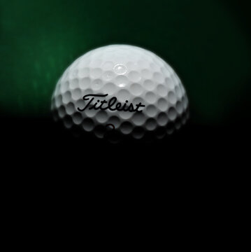 Greenville, SC - USA - 10-25-2023: A Titleist golf ball on the green lit from above