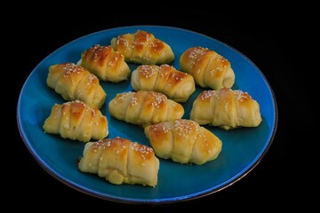 Closeup of freshly-baked croissants on a blue plate
