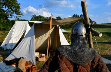 A close up on a remnants of viking or medieval temporary camp, including wooden chests, tools,...