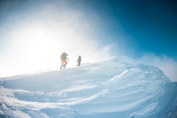 Foto op Plexiglas two girls climb the mountain. © zhukovvvlad