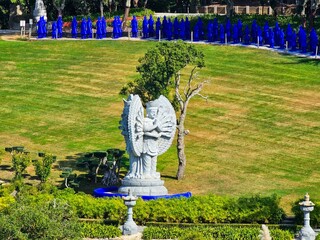 there is a statue of a large angel in the garden