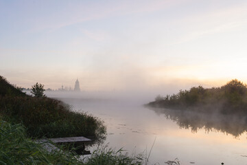 autumn landscape with soft morning light, church at dawn in the fog. Suzdal, Russia
