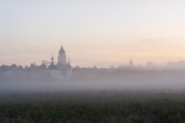 autumn landscape with soft morning light, church at dawn in the fog. Suzdal, Russia - obrazy, fototapety, plakaty