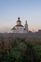 autumn landscape with soft morning light, church at dawn in the fog. Suzdal, Russia - obrazy, fototapety, plakaty