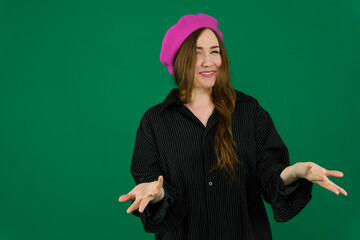 woman on a green background chromakey in a black striped mens shirt different emotions facial expression close-up advertising space for text clean. kind eyes