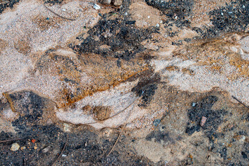 Geological detail of coarse sand gravel in the mountain woods with water flowing marks