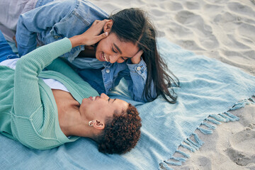 Love, picnic and smile, lesbian couple on blanket together, holding hands on sand and holiday...