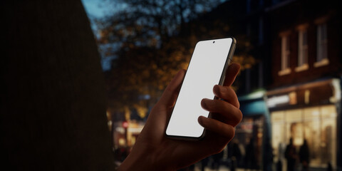 CU Caucasian male using his phone in the street, evening, blank screen mockup