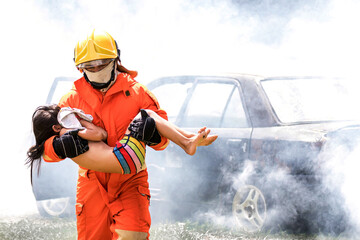 Firefighter to save girl in fire and smoke. Rescue Team or Firefighters save lives people from...