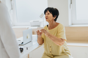 Elderly patient visits a doctor for a diagnosis and health consultation. The doctor analyzes results, explains health issues, and provides medical care and support.