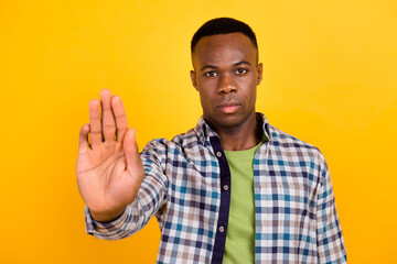 Fototapeta premium Photo of young concentrated worker guy wear plaid shirt demonstrate stop enough discrimination isolated on yellow color background
