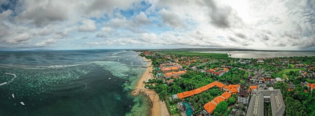 Aerial view of a luxurious coastal resort located on a sunny beach of a tropical island in Indonesia