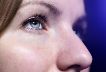 Close up,Tired woman's eyes. Girl is working on internet.
