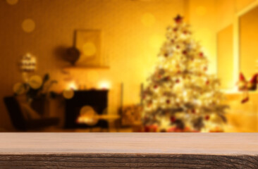 Wooden table in room decorated for Christmas. Space for design